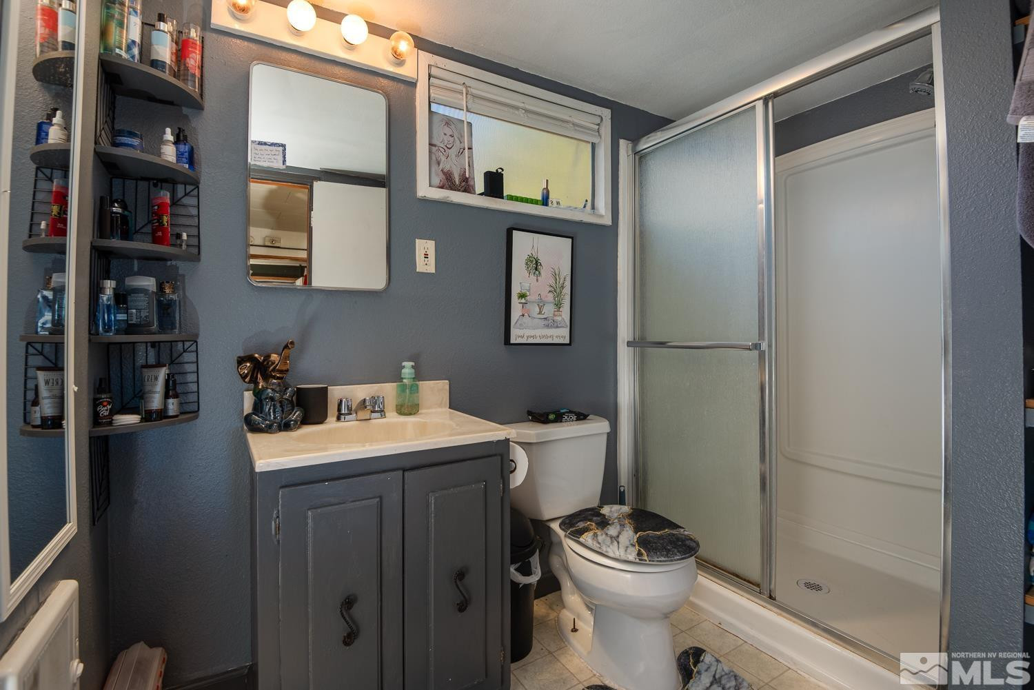 4240 Kings Canyon Road Carson City, NV 89703 - Photo 14 of 25 a bathroom with a toilet sink and shower