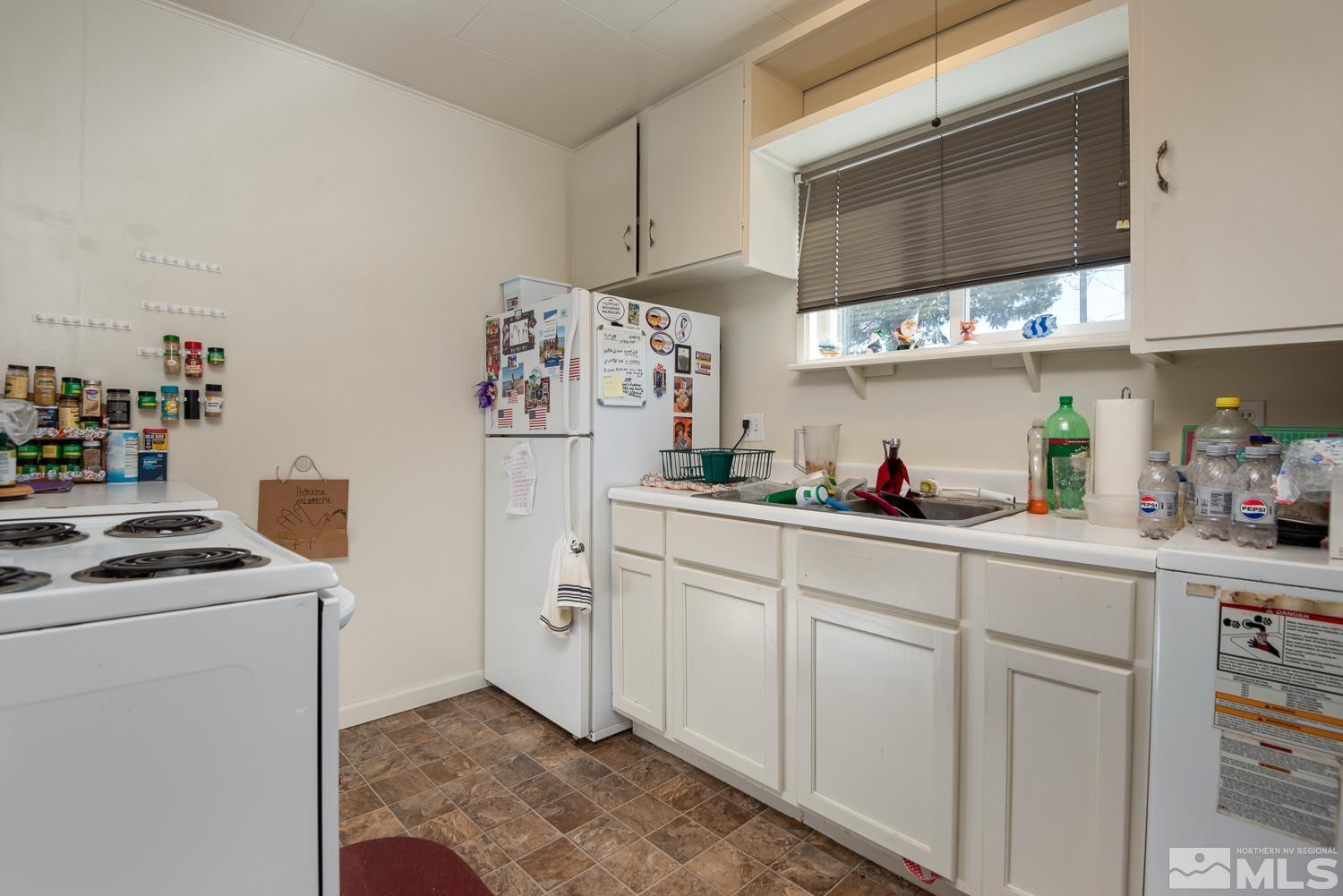 4240 Kings Canyon Road Carson City, NV 89703 - Photo 20 of 25 a kitchen with stainless steel appliances granite countertop a sink and a refrigerator
