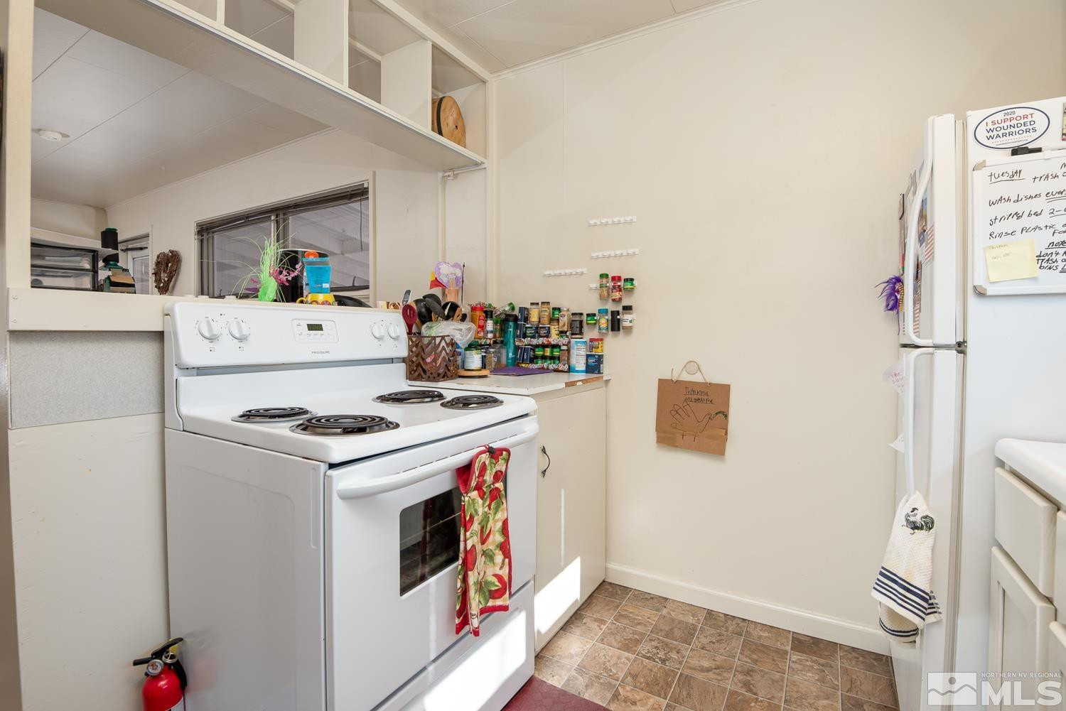 4240 Kings Canyon Road Carson City, NV 89703 - Photo 21 of 25 a kitchen with a stove and a refrigerator