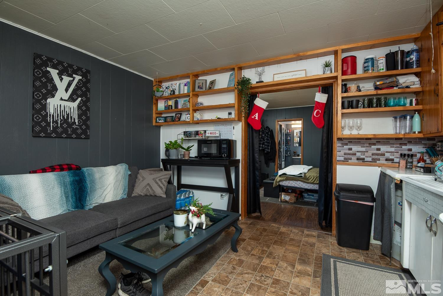 4240 Kings Canyon Road Carson City, NV 89703 - Photo 10 of 25 a living room with furniture and a book shelf