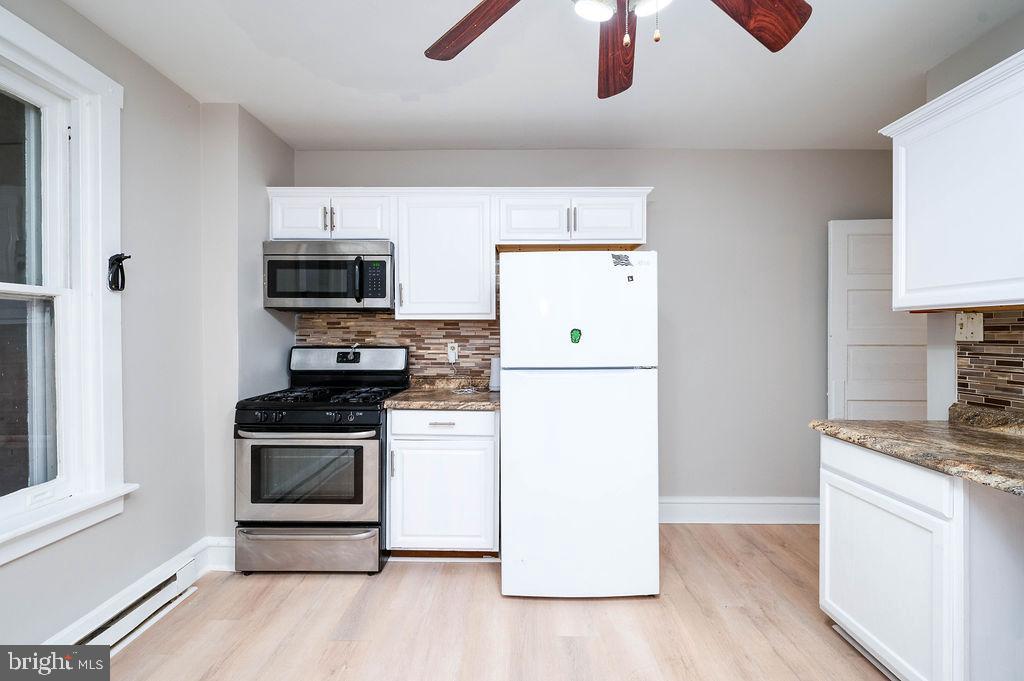 3523 Ridgeway Street Reading, PA 19605 - Photo 8 of 23 a kitchen with stainless steel appliances granite countertop a stove a sink and a refrigerator