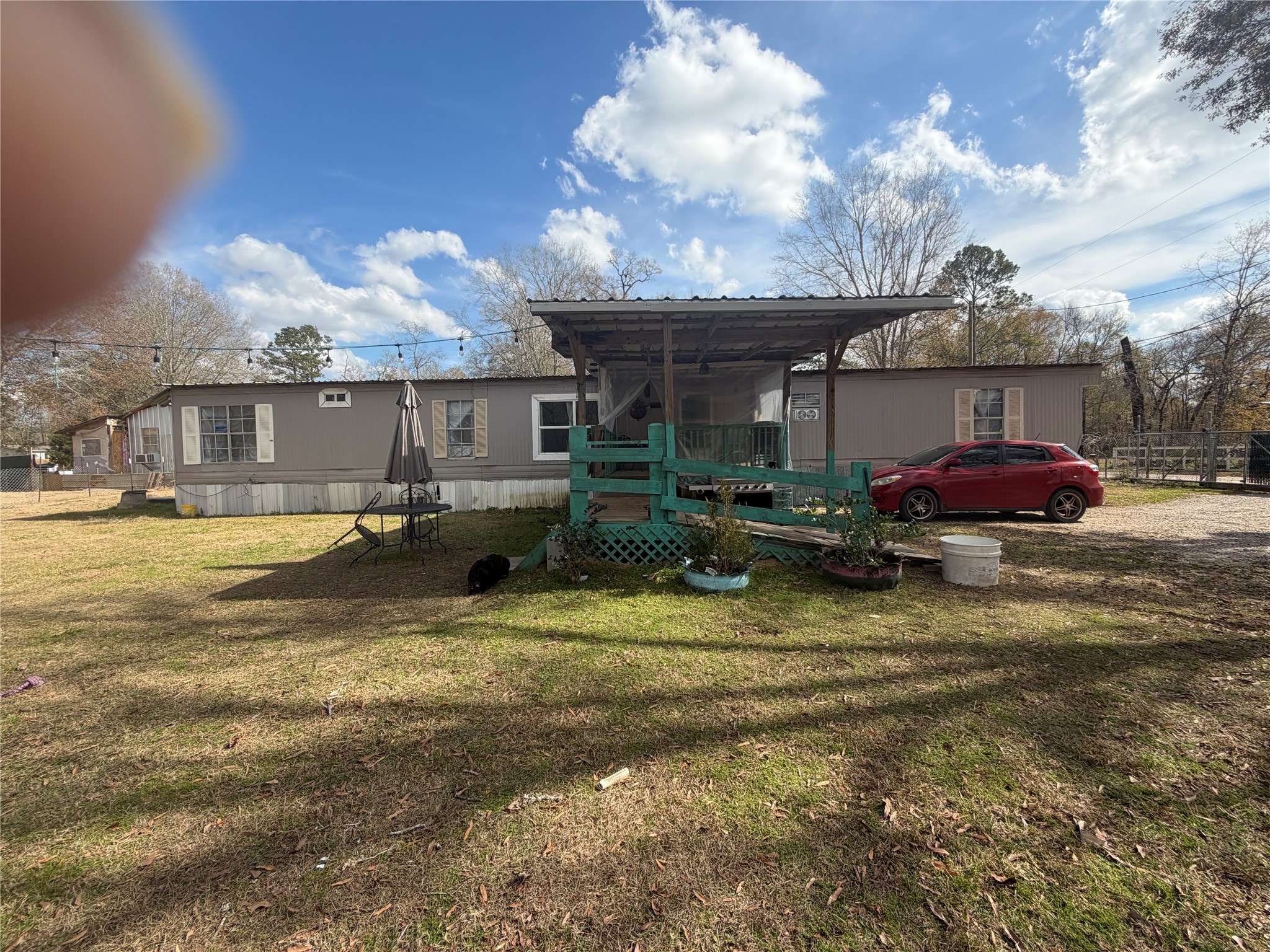 a front view of house with yard and car parked
