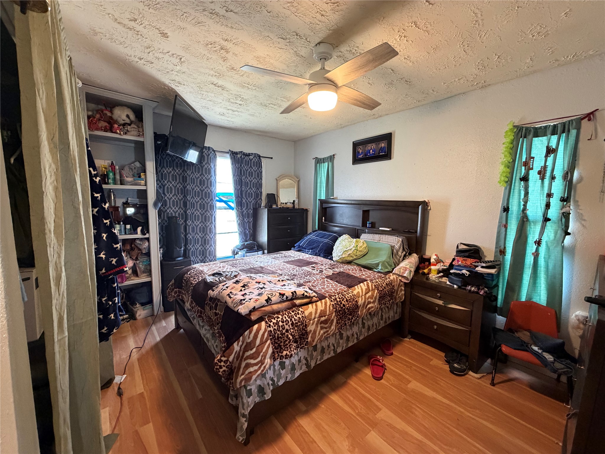 11 June Lane Shepherd, TX 77371 - Photo 11 of 33 a bedroom with a bed and a chandelier