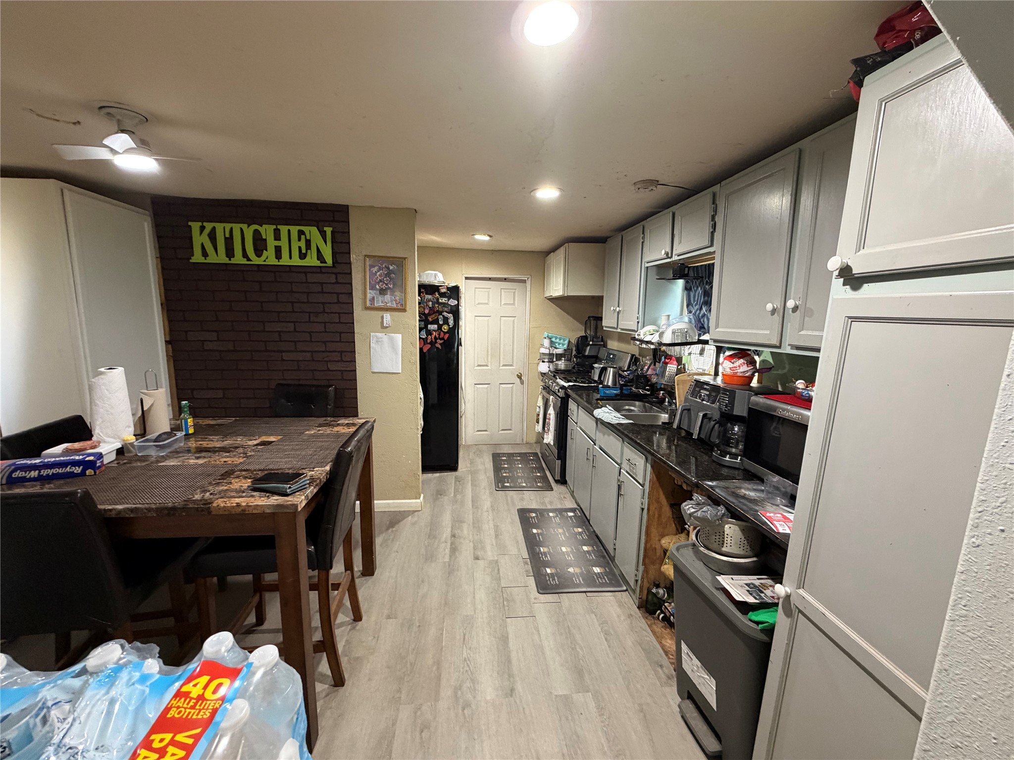 11 June Lane Shepherd, TX 77371 - Photo 13 of 33 a kitchen with stainless steel appliances refrigerator stove microwave and cabinets