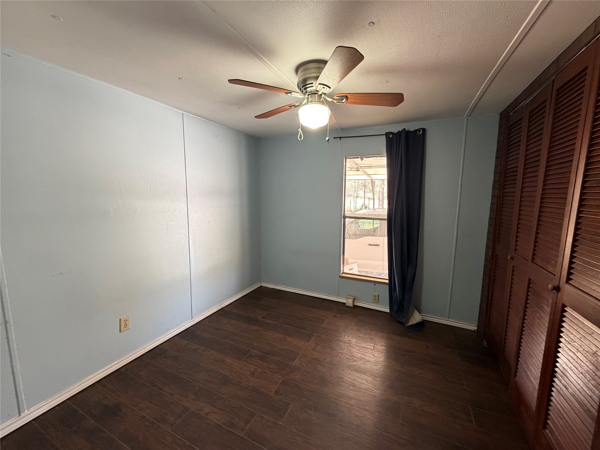 11 June Lane Shepherd, TX 77371 - Photo 20 of 33 an empty room with wooden floor fan and window