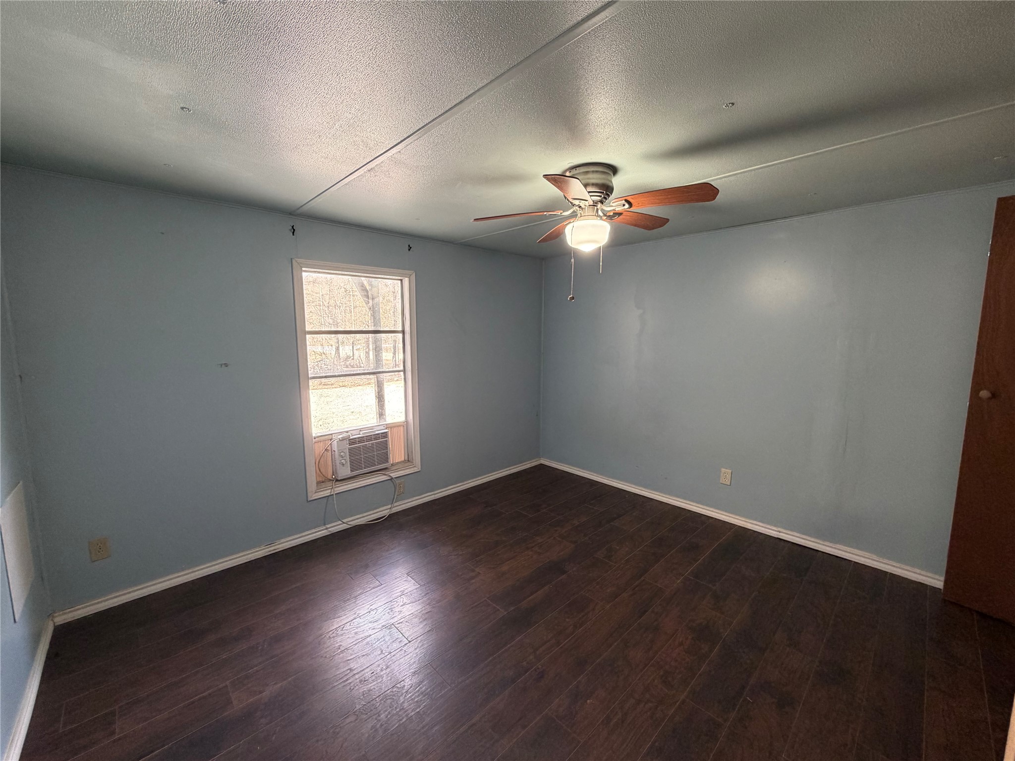 11 June Lane Shepherd, TX 77371 - Photo 23 of 33 an empty room with wooden floor chandelier fan and windows