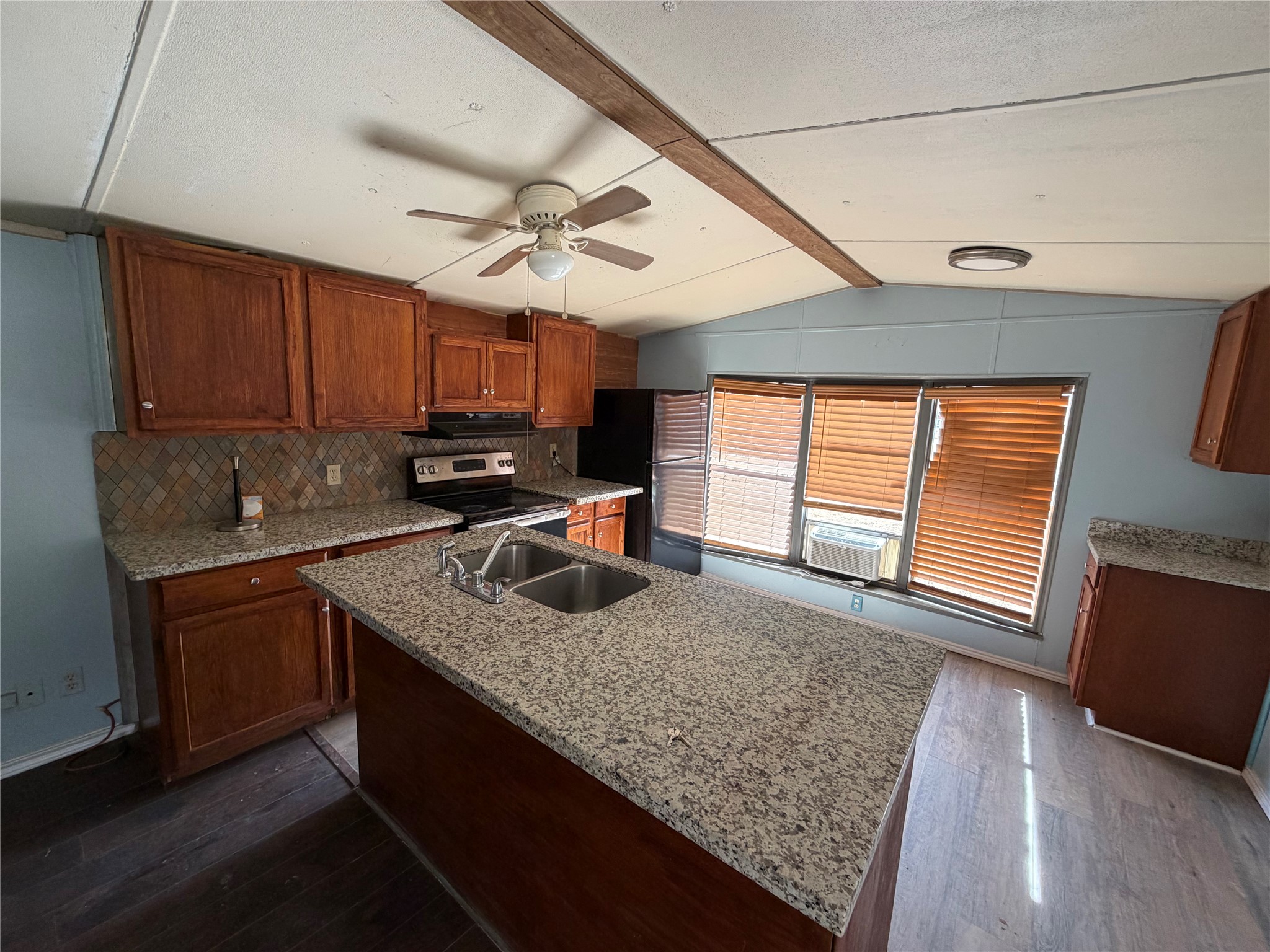 11 June Lane Shepherd, TX 77371 - Photo 28 of 33 a kitchen with stainless steel appliances granite countertop a sink a stove cabinets counter space and a window