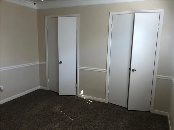 an empty room with closet area