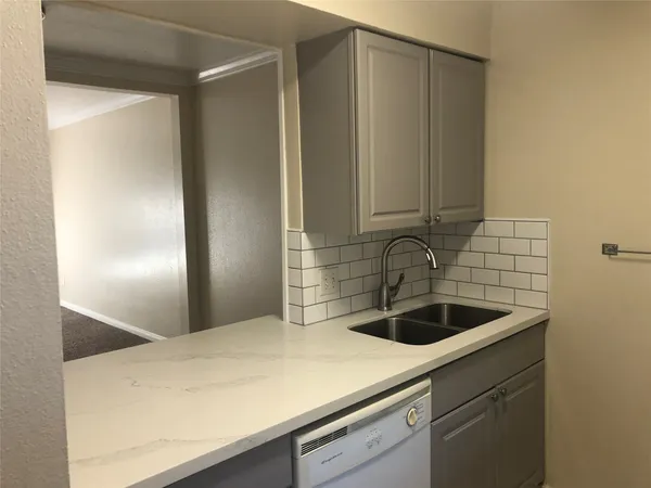 a kitchen with a sink and cabinets