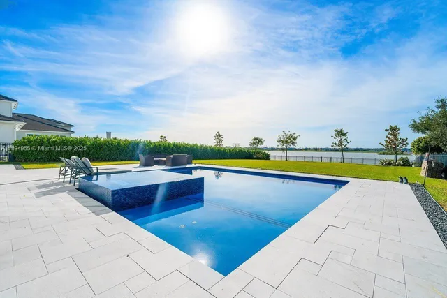 a view of swimming pool with seating space