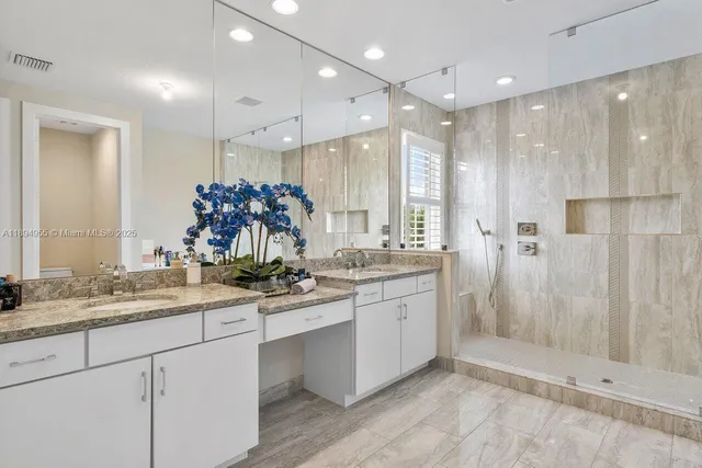a bathroom with a granite countertop sink mirror and double