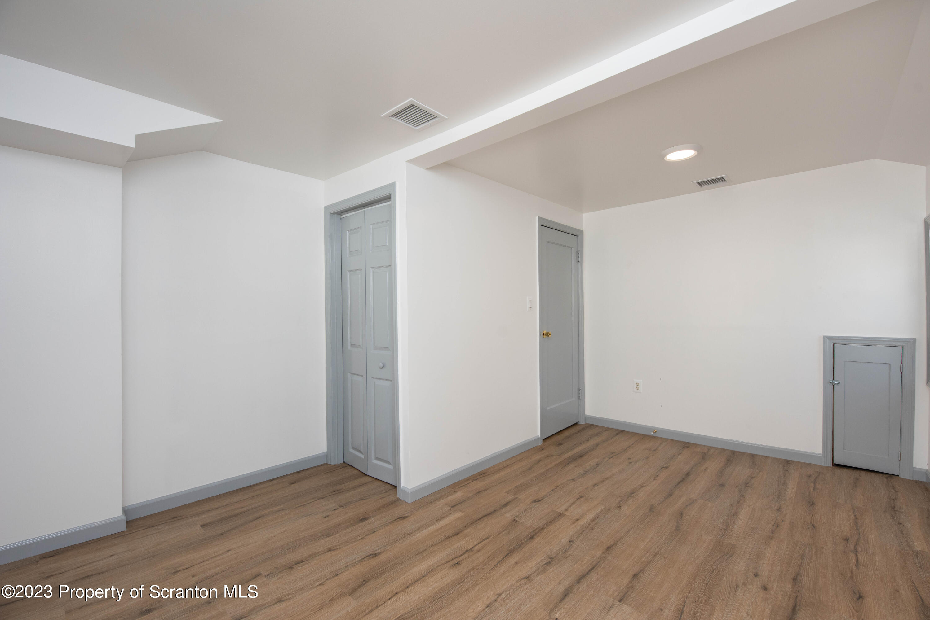 124 Delaware Avenue Olyphant, PA 18447 - Photo 20 of 30 a view of an empty room with wooden floor