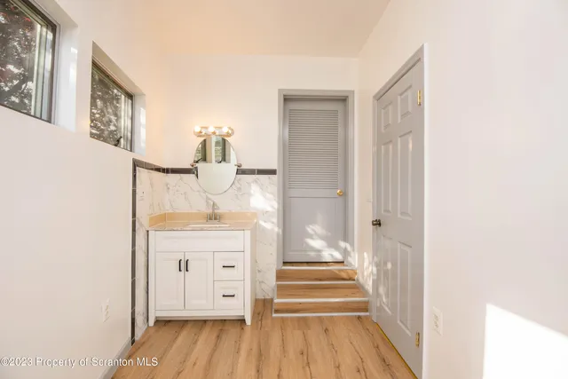 a hallway with mirror and window