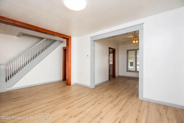 a view of hallway with wooden floor