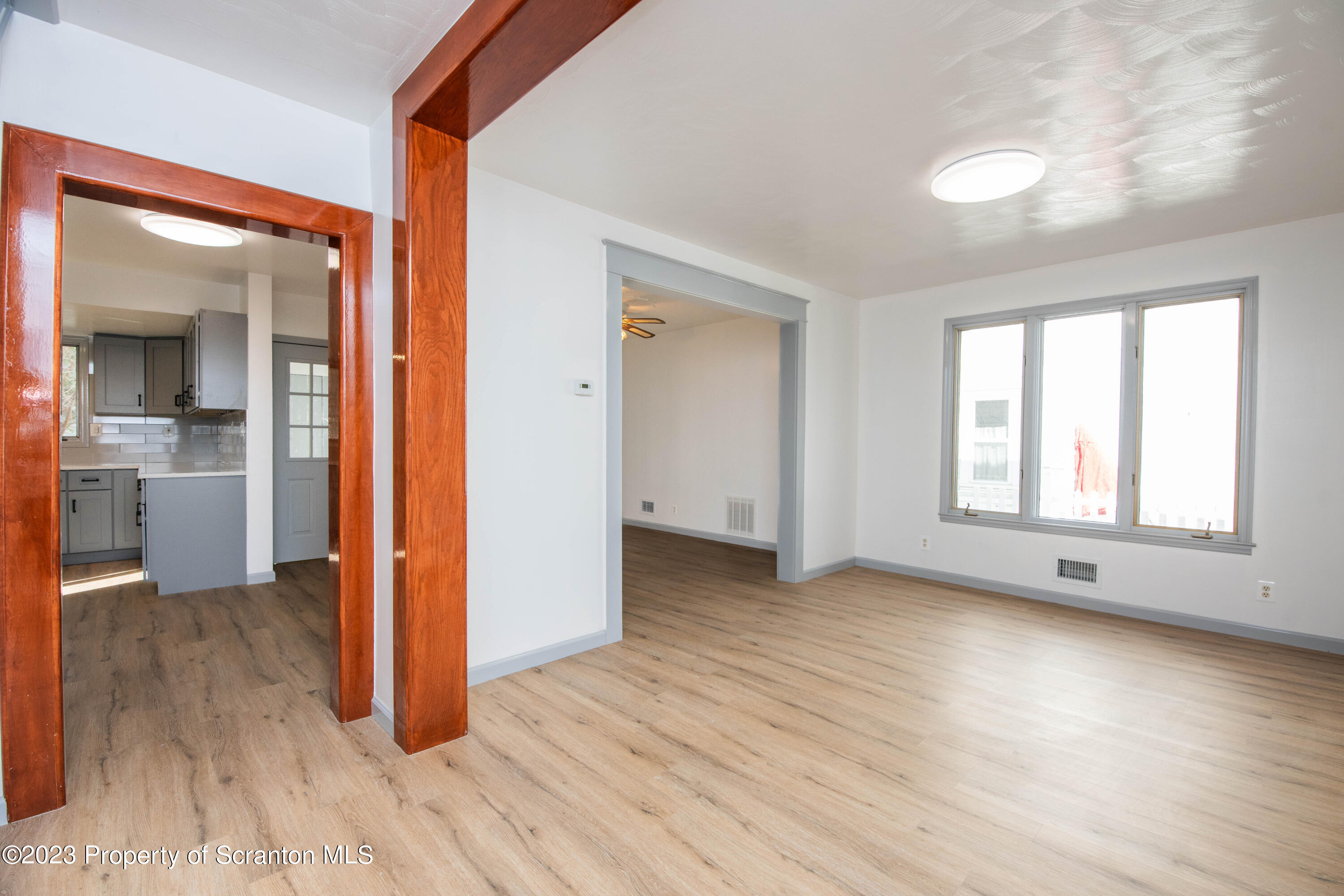 124 Delaware Avenue Olyphant, PA 18447 - Photo 4 of 30 an empty room with wooden floor and a window