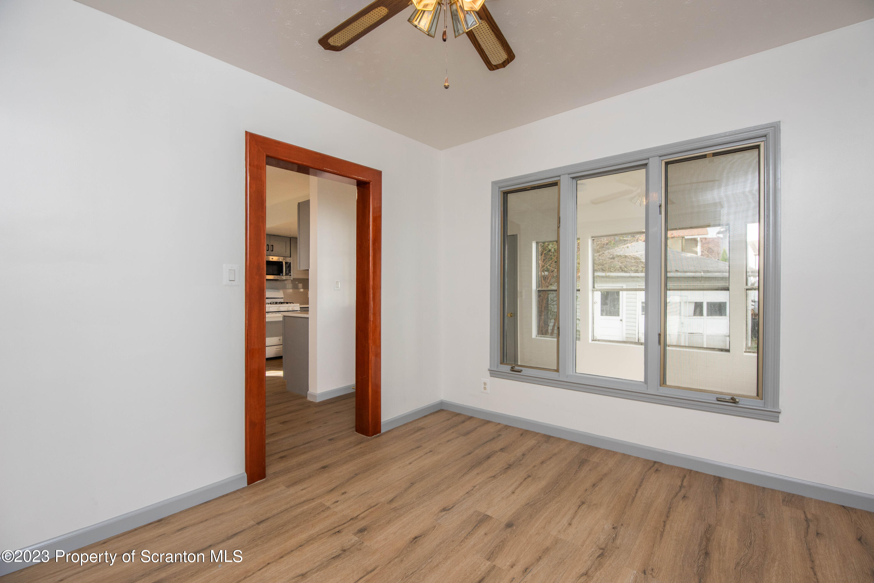 124 Delaware Avenue Olyphant, PA 18447 - Photo 5 of 30 an empty room with ceiling fan and window
