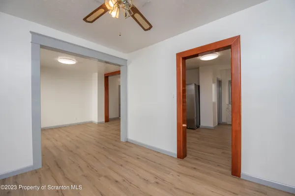 a view of a hallway with wooden floor