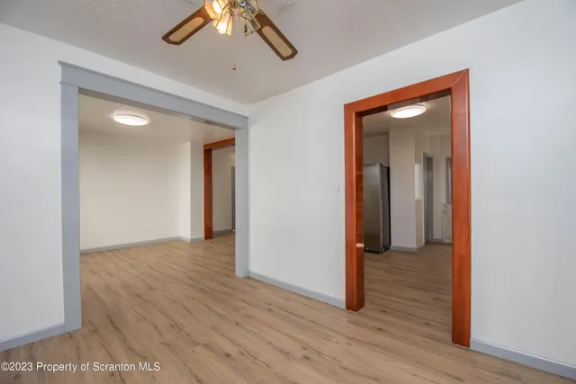 a view of a hallway with wooden floor