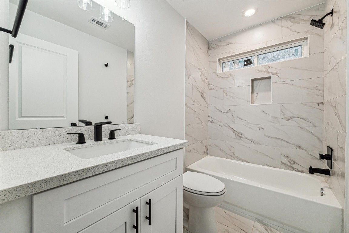 978 Marjorie Street, Unit 1 Houston, TX 77088 - Photo 11 of 12 a bathroom with a sink a toilet and shower