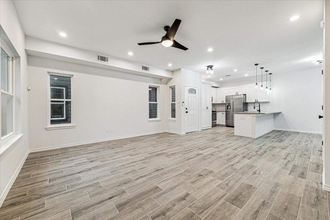 978 Marjorie Street, Unit 1 Houston, TX 77088 - Photo 5 of 12 a view of kitchen and empty room with wooden floor