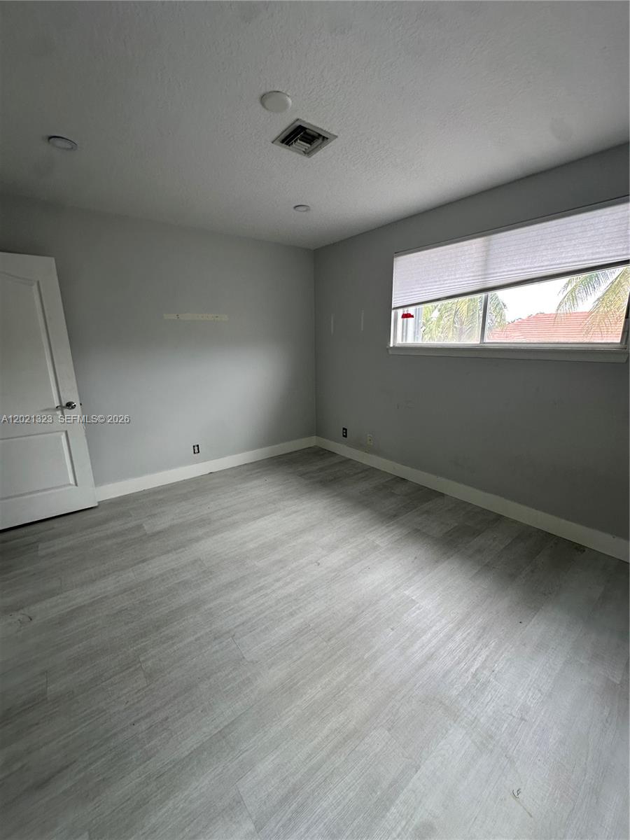 354 Mallard Road, Unit O Weston, FL 33327 - Photo 20 of 29 a view of an empty room with wooden floor and fan