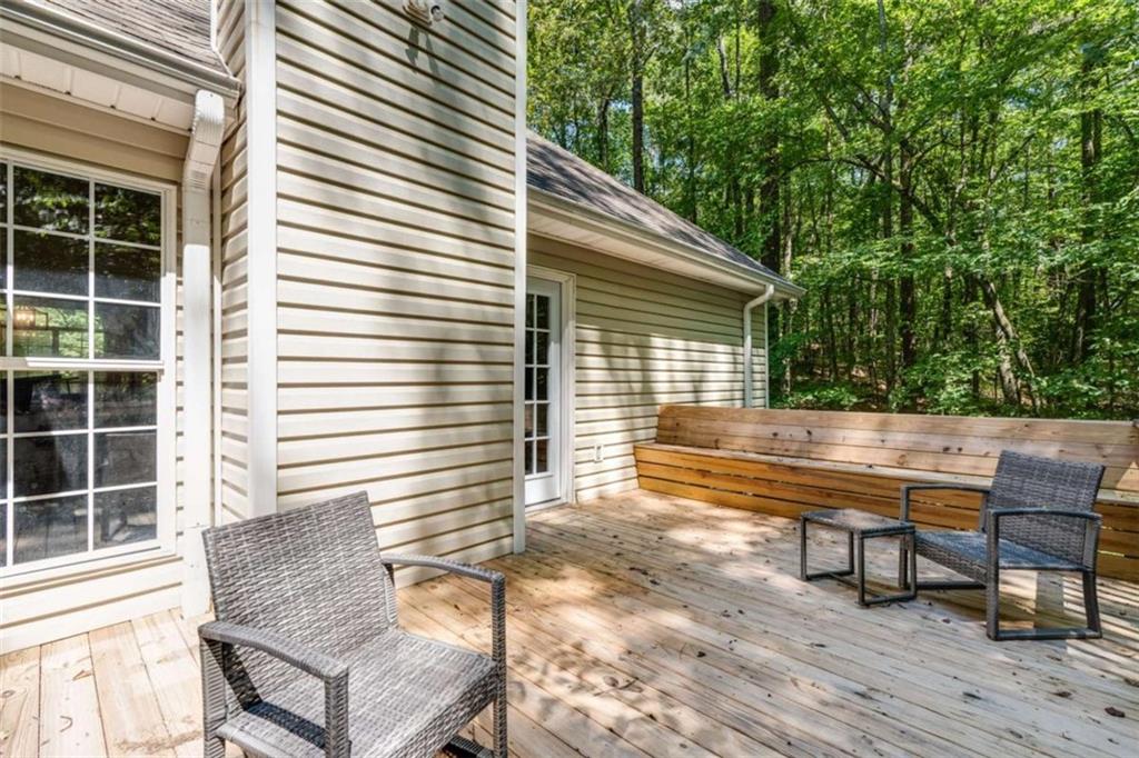 2219 Harper Drive Villa Rica, GA 30180 - Photo 24 of 25 a view of a deck with two chairs and a potted plant