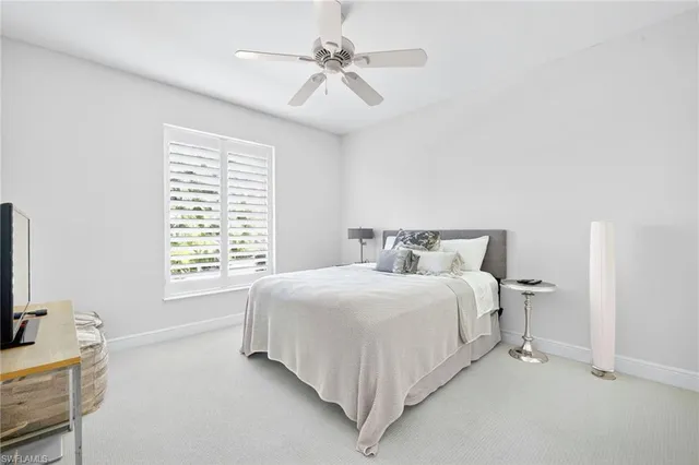a bedroom with a bed and a flat tv screen on the dresser