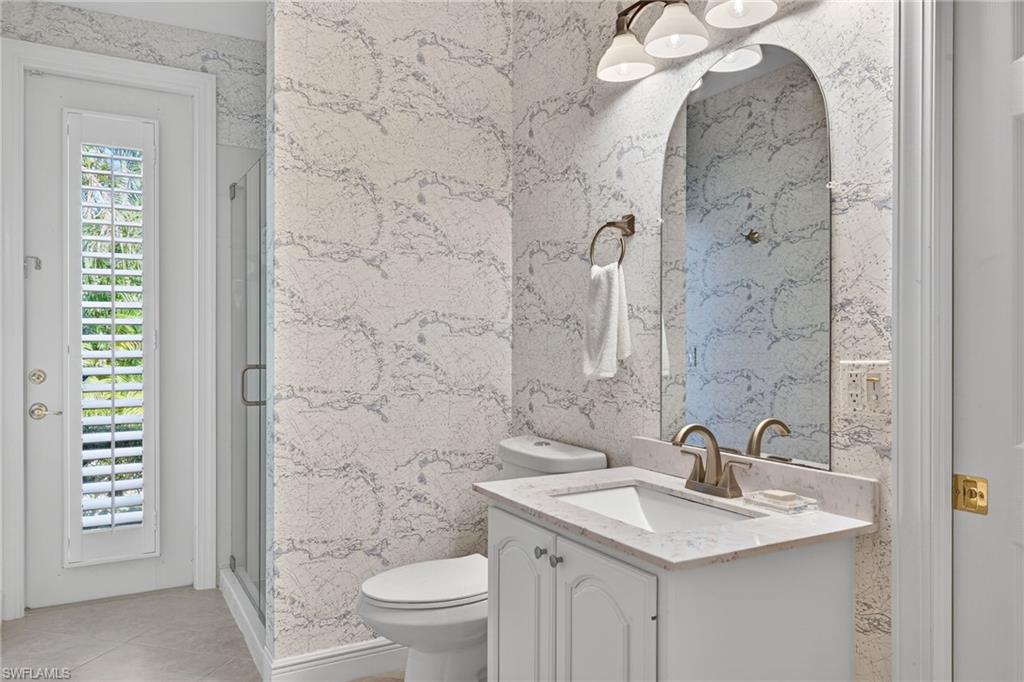 2229 Goshawk Court Naples, FL 34105 - Photo 16 of 26 a bathroom with a sink a toilet and shower