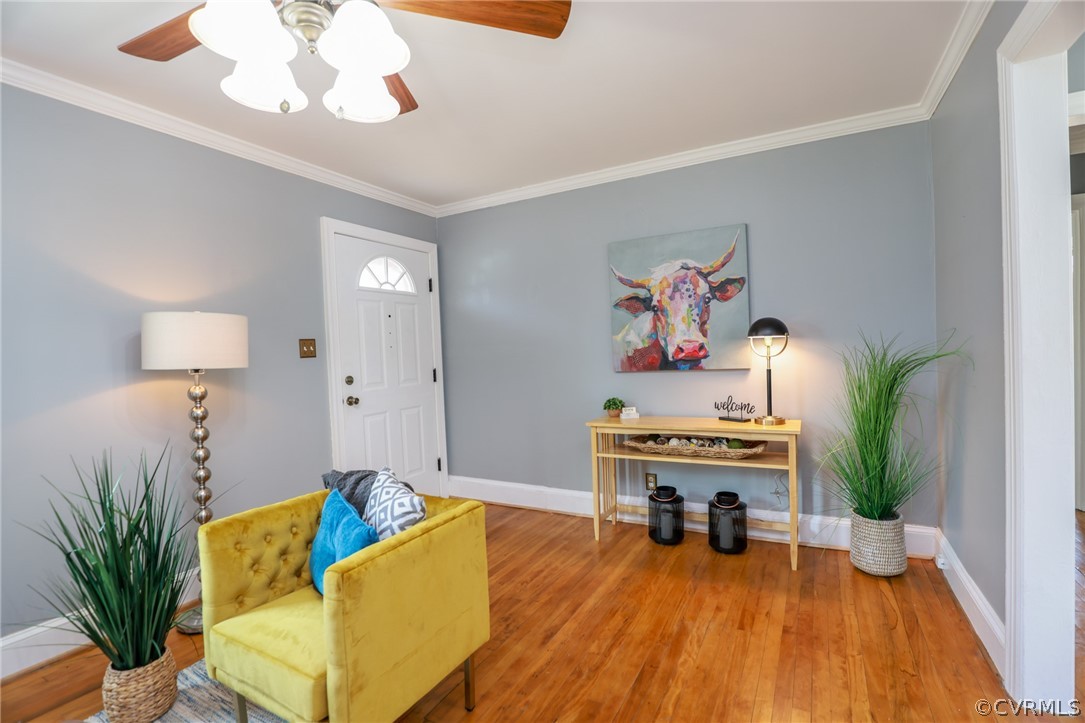 Living Room with crown molding, wood floors and lo