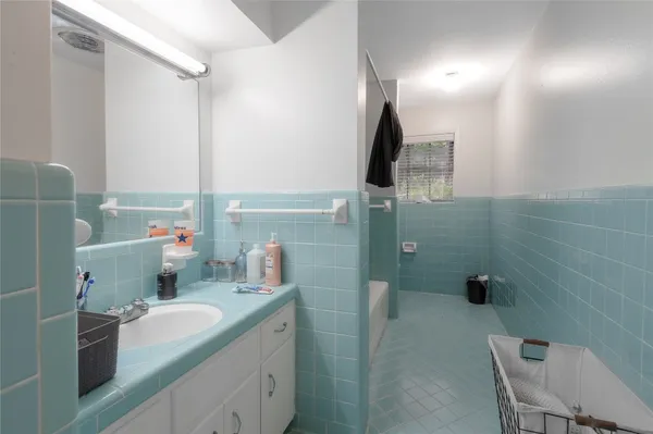 a bathroom with a double vanity sink a toilet and a mirror