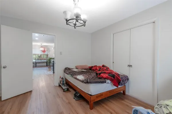 a bedroom with a bed and a chandelier