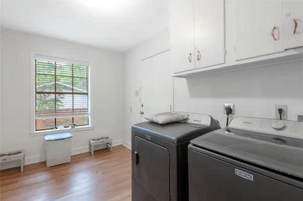 a utility room with sink dryer and washer