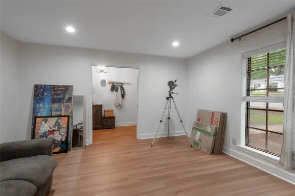 a view of a livingroom with furniture and a hallway