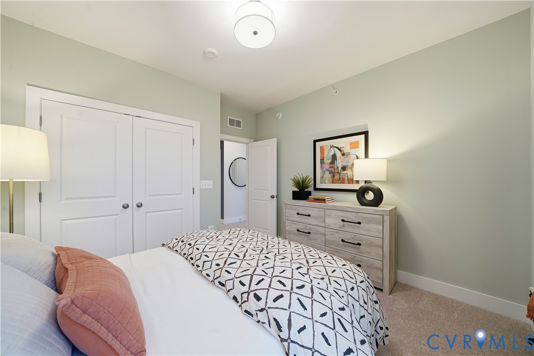 9881 Tuco Street, Unit B Glen Allen, VA 23059 - Photo 25 of 50 a bedroom with a bed and a dresser in it