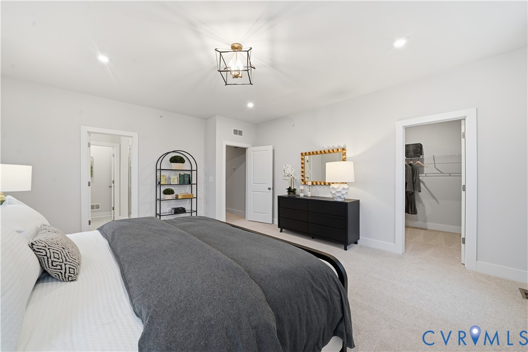 9881 Tuco Street, Unit B Glen Allen, VA 23059 - Photo 31 of 50 a bedroom with a bed and a chandelier