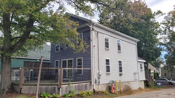 a view of house with a tree in the background
