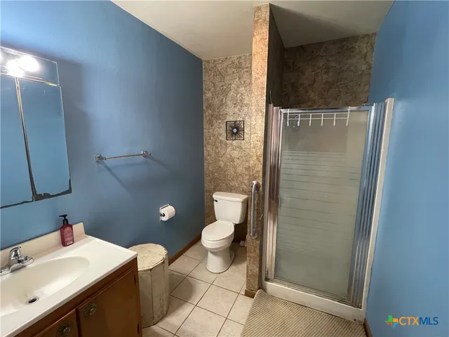 a bathroom with a toilet a sink and shower