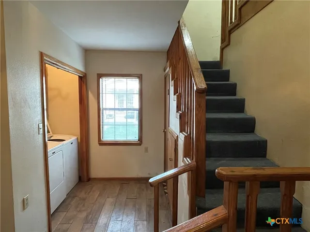a view of entryway with wooden floor and stairs