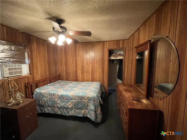 a bedroom with a bed and a mirror