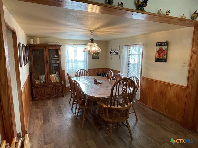 a view of a dining room with furniture and window