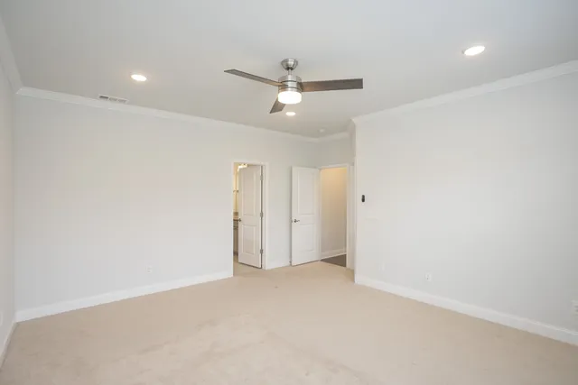 an empty room with a ceiling fan and a window