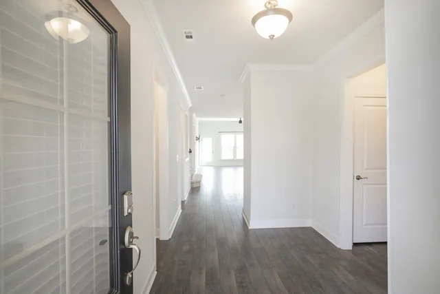 a view of a hallway with wooden floor