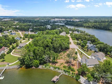 an aerial view of lake residential house with outdoor space and trees around