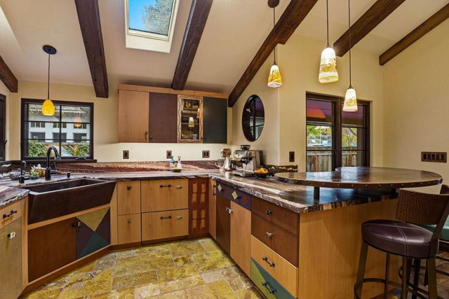 a kitchen with stainless steel appliances granite countertop sink stove and cabinets