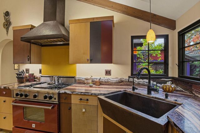 a kitchen that has a sink and a stove