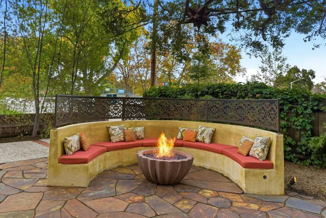 a view of a couches in the patio with potted plants