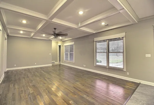 an empty room with closet and a chandelier fan