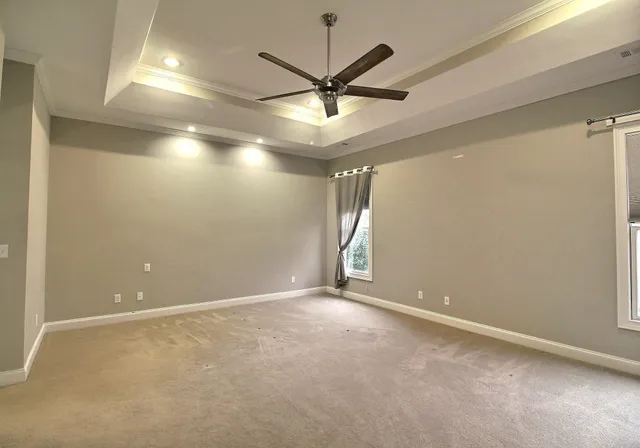 a bathroom with a granite countertop sink a toilet a mirror and shower