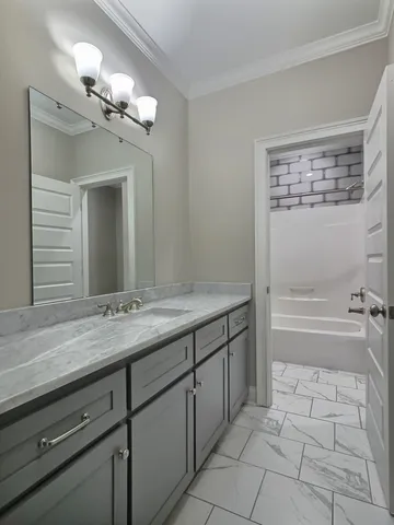 an empty room and a chandelier fan