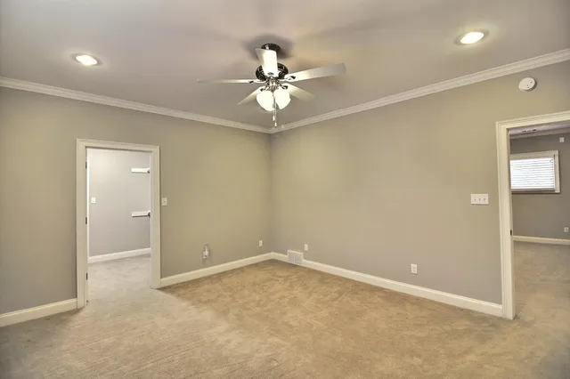 a kitchen with stainless steel appliances granite countertop a stove a sink and a white cabinets